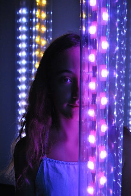 Portrait of a girl illuminated by colorful neon LED lights creating a moody atmosphere.