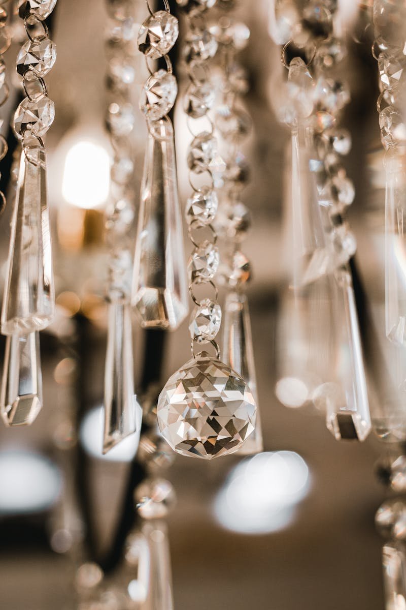 Close-up of a sparkling crystal chandelier with delicate details and soft lighting.