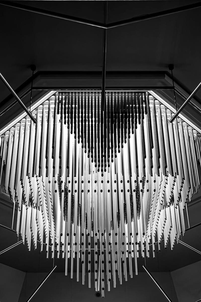 Artistic black and white shot of a modern, futuristic chandelier with geometric patterns, enhancing contemporary interiors.