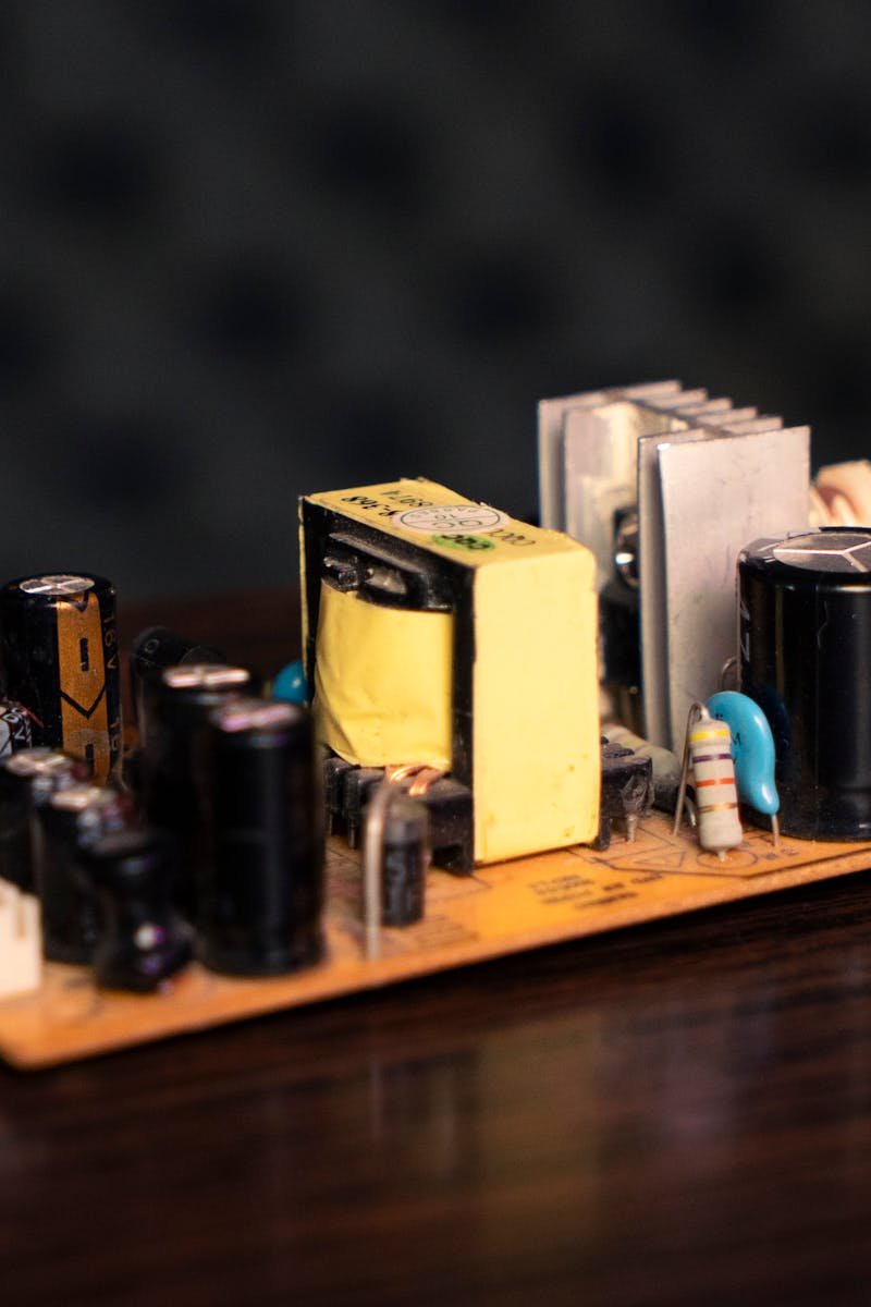 Close-up of an electronic circuit board showcasing capacitors, resistors, and transformers.