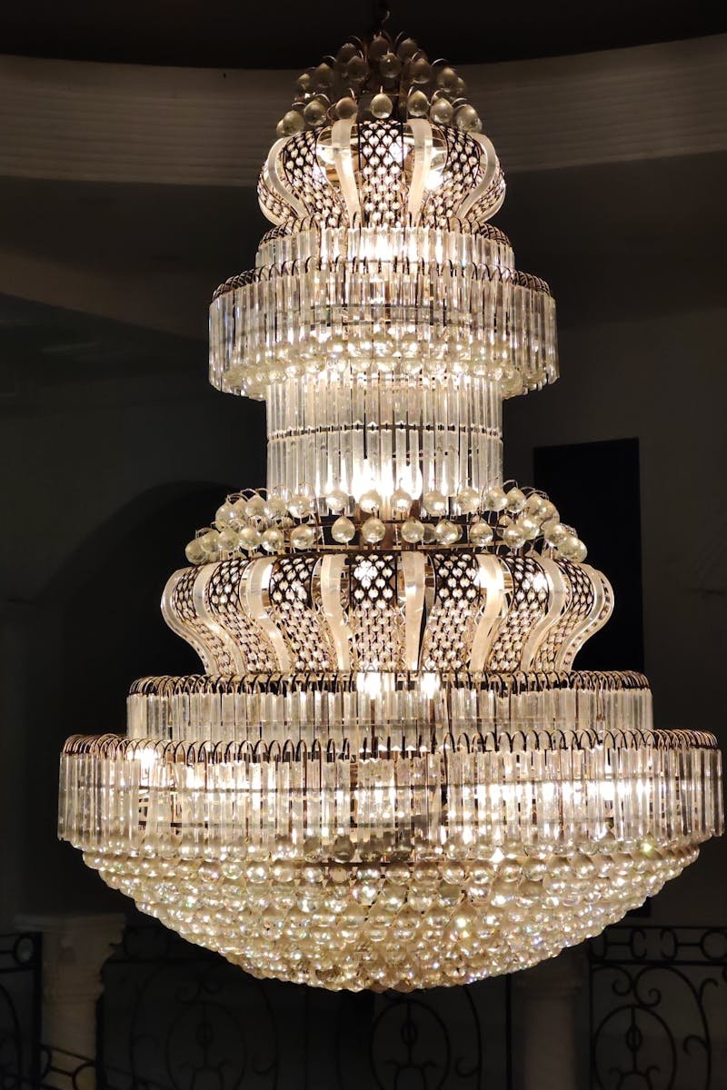 Stunning crystal chandelier illuminated in an elegant indoor setting, showcasing opulence and luxury.